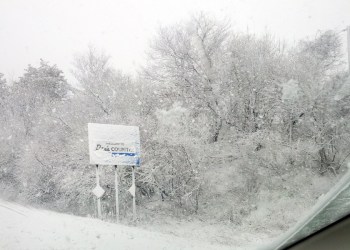 The snow covered Dan's Country sign near Exit 68 on 495 Monday morning