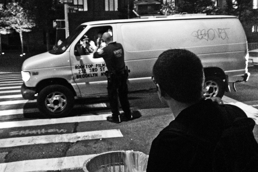 Police stop a van during the David Koch Plaza protest and dedication