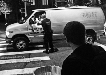 Police stop a van during the David Koch Plaza protest and dedication