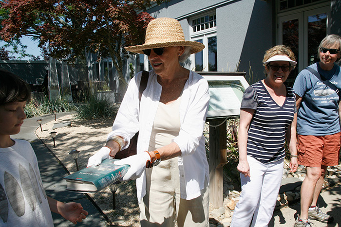 People pass the last book to go into the newly renovated John Jermain Memorial Library down Sag Harbor’s Main Street last Saturday