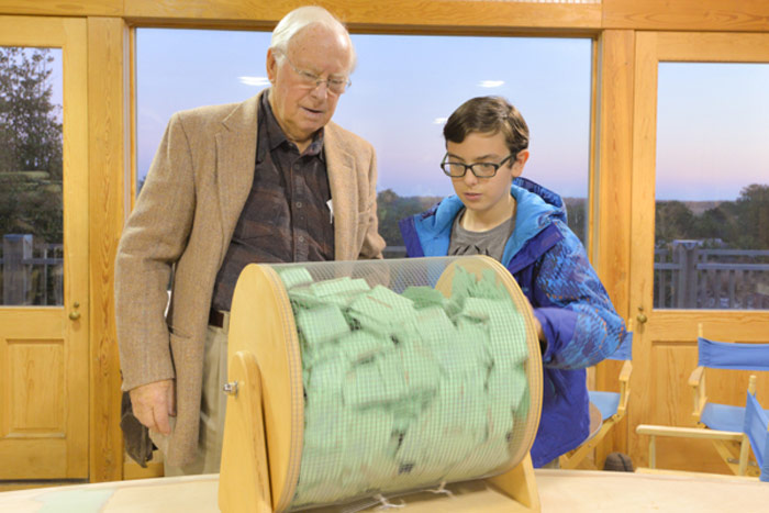 East End Classic Boat Society President Ray Hartjen watches Frank Piekarz, 11, pick the winner.