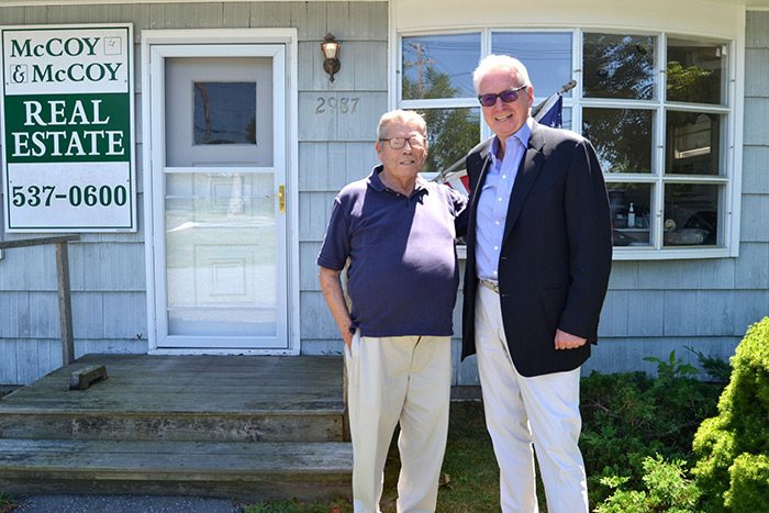 William McCoy and Paul Brennan in front of Douglas Elliman's new office in Sagaponack