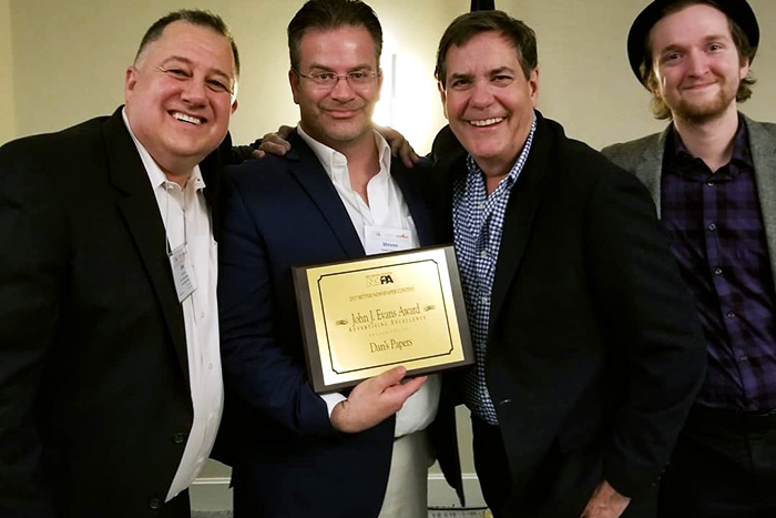 Dan's Hamptons COO Eric Feil, CEO Steve McKenna, Head of Advertising Dan Schock and Assistant Editor David Taylor show off Dan's Papers' John J. Evans Award for Advertising Excellence at the New York Press Association 2017 Better Newspaper Contest