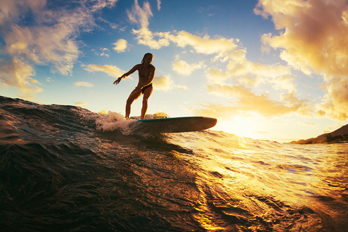 Female surfer sunset