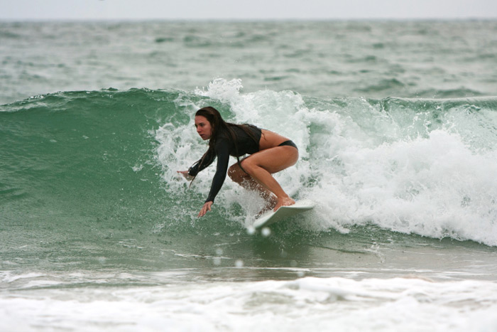 Female surfer catching a wave