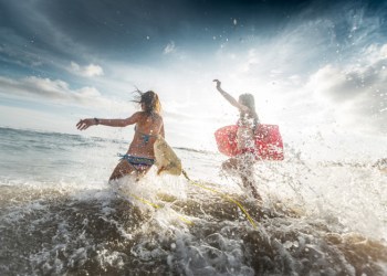 Female surfers and ocean wave