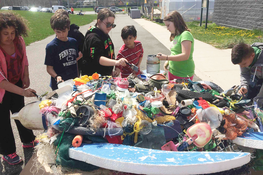 Hampton Bays Middle School students create "Gurtle," a sculpture of a leatherback sea turtle made out of garbage collected on local beaches.