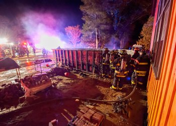 East Hampton firefighters extinguish a dumpster fire Sunday.