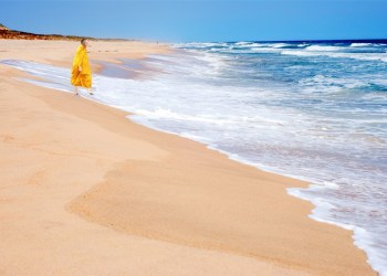 Derwood Hodgegrass wearing robes on the beach