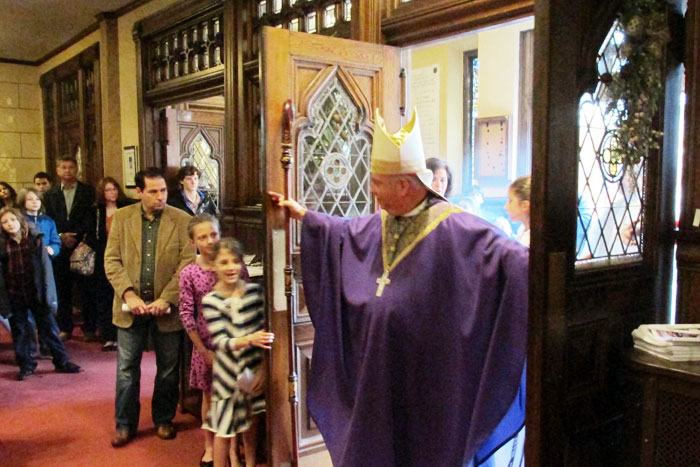 Bishop Nelson Perez opens the main aisle door of Sacred Heart of Jesus & Mary as a Door of Mercy