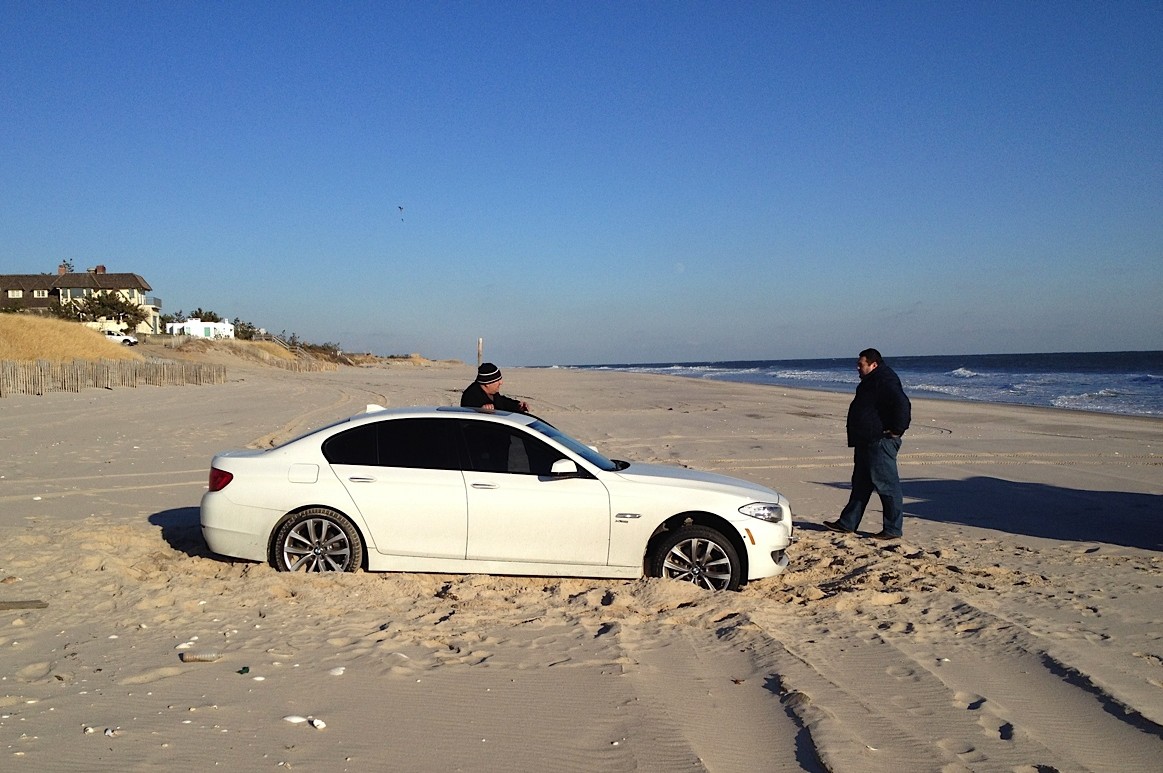 BMW stuck in the sand at Old Town Beach, Southampton Village.