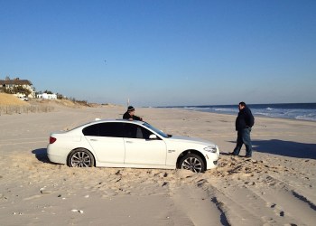 BMW stuck in the sand at Old Town Beach, Southampton Village.