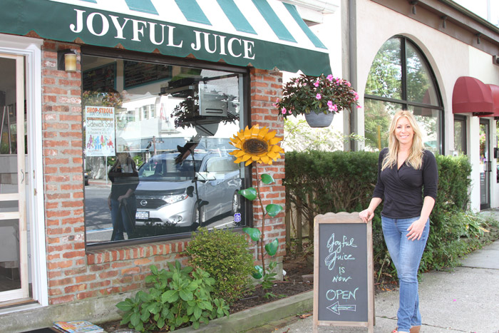 Owner and raw chef Dorie Lake in front of her new shop, Deliciously Dories Joyful Juice.