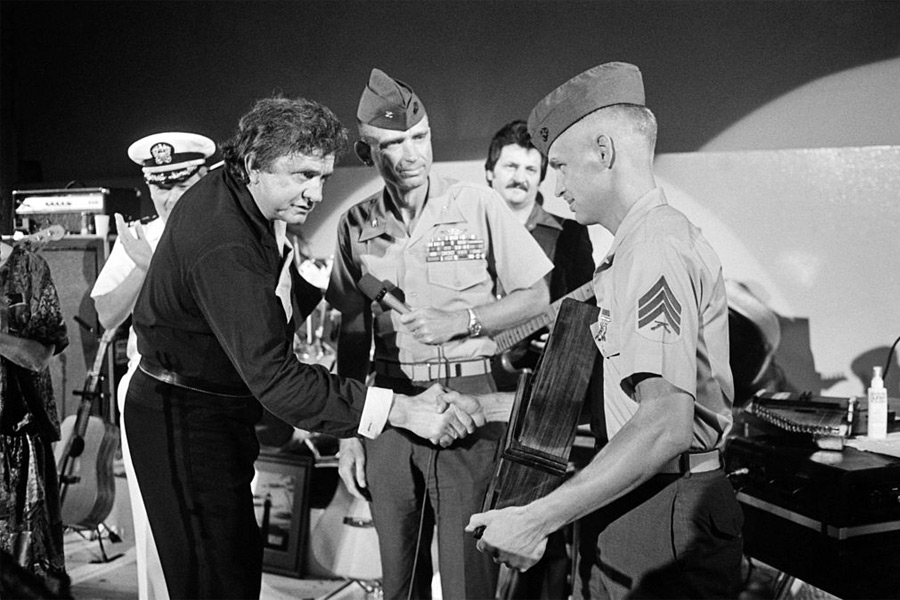 Johnny Cash receives an award from a Marine sergeant