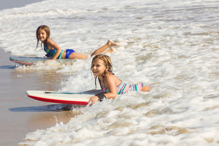 Little girls boogie boarding