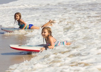 Little girls boogie boarding