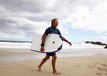 Mature boogie boarder surf