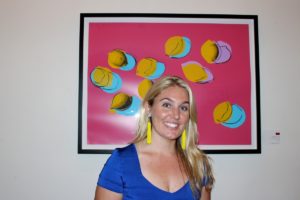 Maura Smith, of Christie's, stands in front of "Space Fruit: Lemons," by Andy Warhol.