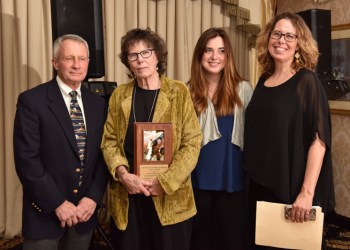 Diane and Melinda Novak, with daughter Chela, receive the Phoenix Award from Dr. John Andresen
