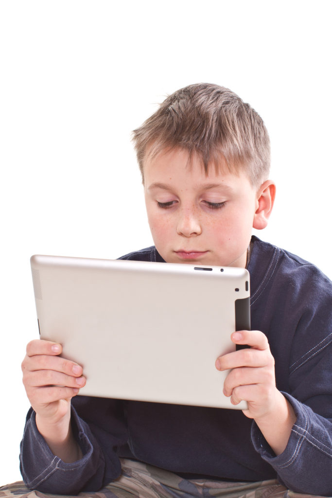 Teen plays on the tablet computer