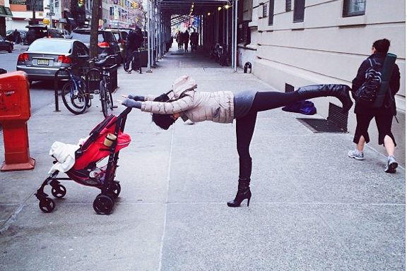 Hilaria Baldwin does Warrior III yoga posture.