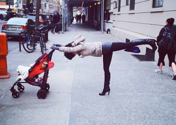Hilaria Baldwin does Warrior III yoga posture.