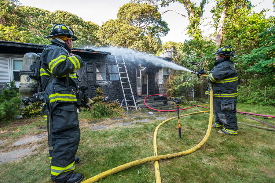 Members of Springs Fire Department battle a house fire on Tuesday