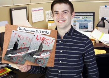 Landon Jones shows off his research materials about the Hamptons Police Department submarine
