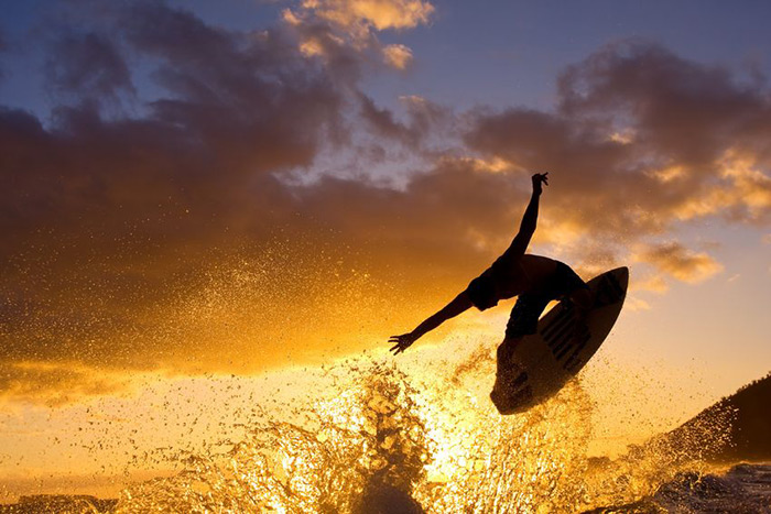 Sunset surfer catching air