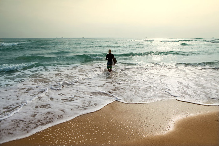 surfer entering water