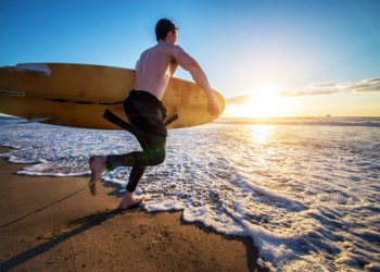 Surfer hits the waves