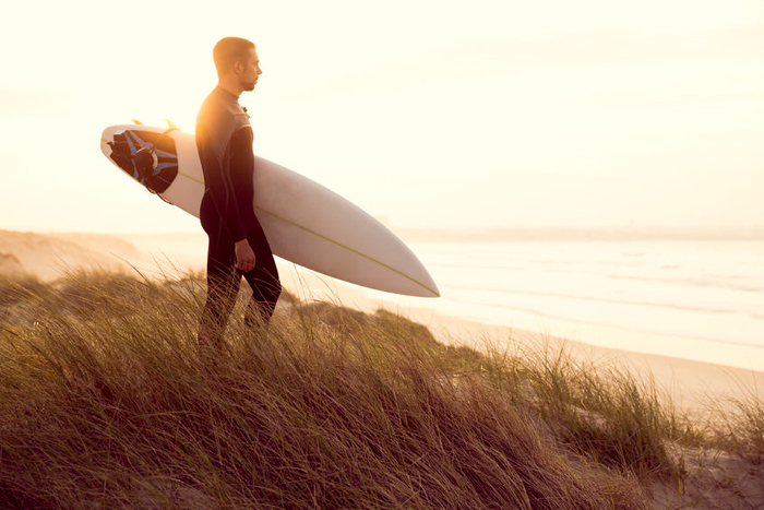 surfer on dune in fullsuit
