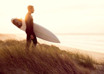 surfer on dune in fullsuit