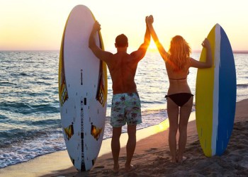 Surfers sunset male female