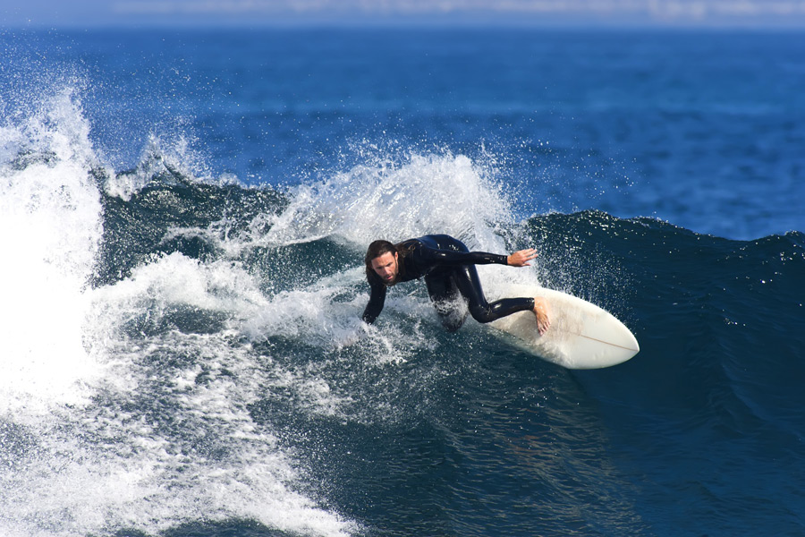 Surfer shredding wave
