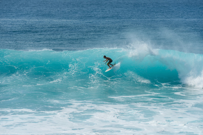Surfing big blue wave in Hawaii