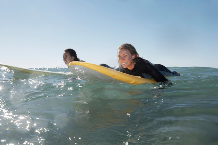 Two surfer girls waiting for a wave