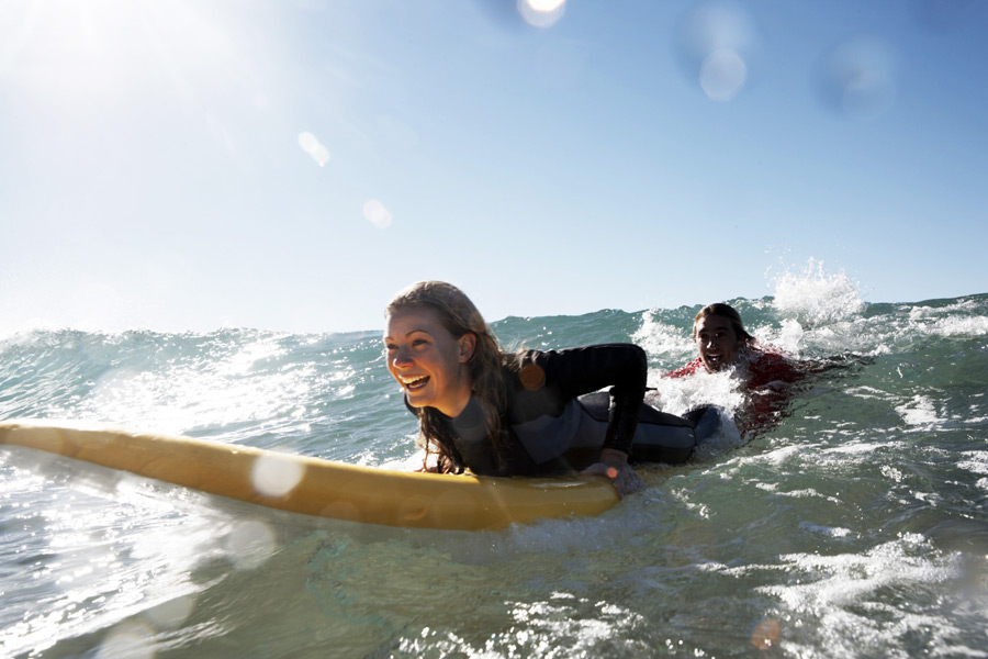 Woman surfing and tows guy in wave, Hamptons Surf Report art