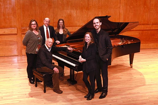 The Stony Brook Music Department faculty and students surround a Bosendorfer Imperial Grand Piano, donated by the Billy Joel Foundation. From back to front are: Christina Dahl, Associate Professor of Piano; Perry Goldstein, Chair, Department of Music; Elizabeth Dorman, Piano Master’s Student; Gilbert Kalish, Distinguished Professor, Piano; Annie Brooks, Piano Masters Student; and David Brooks, (DMA).