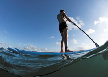 Stand up paddleboarding is a fun fall activity on the water.