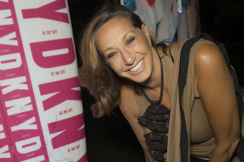 Donna Karan signing the paddle board she designed for the 2014 , Hamptons Paddle & Party for Pink.