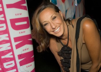 Donna Karan signing the paddle board she designed for the 2014 , Hamptons Paddle & Party for Pink.