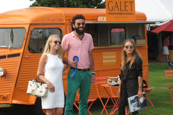 Judges Ashley Cline and Mary-Kate Olsen presented the blue ribbon for the Hampton Classic Boutique Contest to Javier Goggins, one of the owners of Galet.