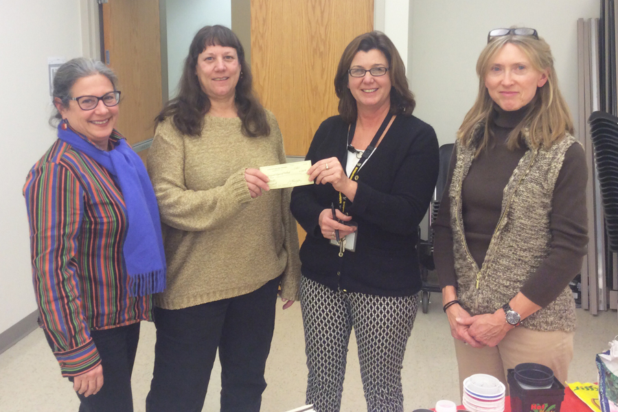 Jessica James (CCOM) and Donna Di Paolo (Montauk Public School) accepting a $500.00 grant from Judiann Carmack- Fayyaz (third from left) representing Slow Foods and the Joshua Levine Foundation at the bimonthly meeting of Schoolyard Gardens of the East End on January 21, 2015, at Cornell Cooperative Extension in Riverhead.