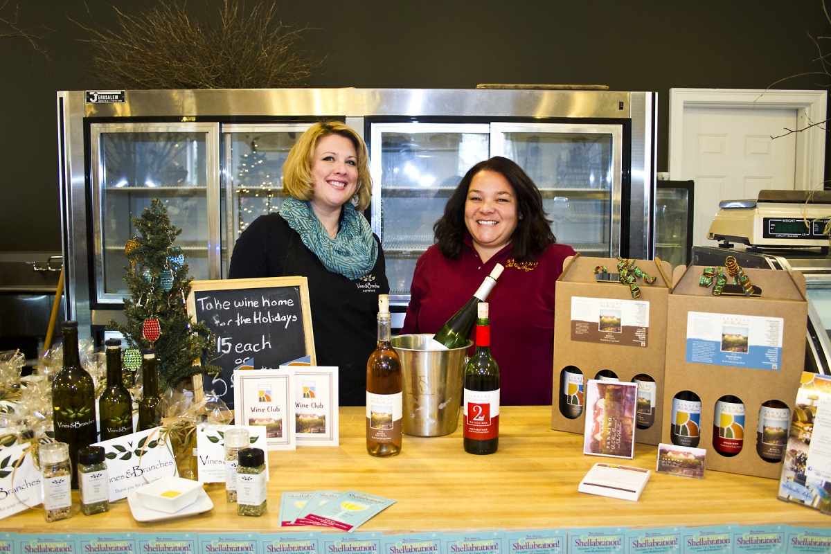 Amber Sidor and Lisa Sannino welcome guests to sample olive oil and Sannino Bella Vita wines at Vines and Branches during Greenport's second annual Shellabration.