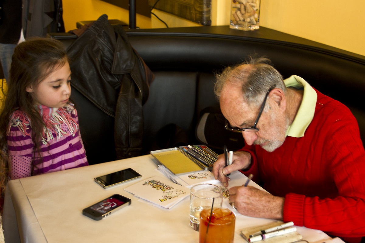 Cartoonist Don Duga draws 6-year-old Madison Ciambra into a Frosty the Snowman cartoon.