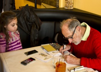 Cartoonist Don Duga draws 6-year-old Madison Ciambra into a Frosty the Snowman cartoon.