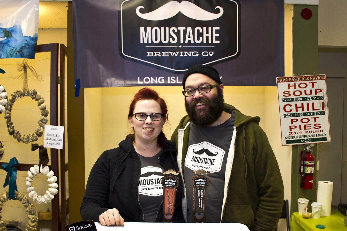 Lauri and Matt Spitz serve Moustache Brewing Co. beer at the Riverhead Farmers Market.