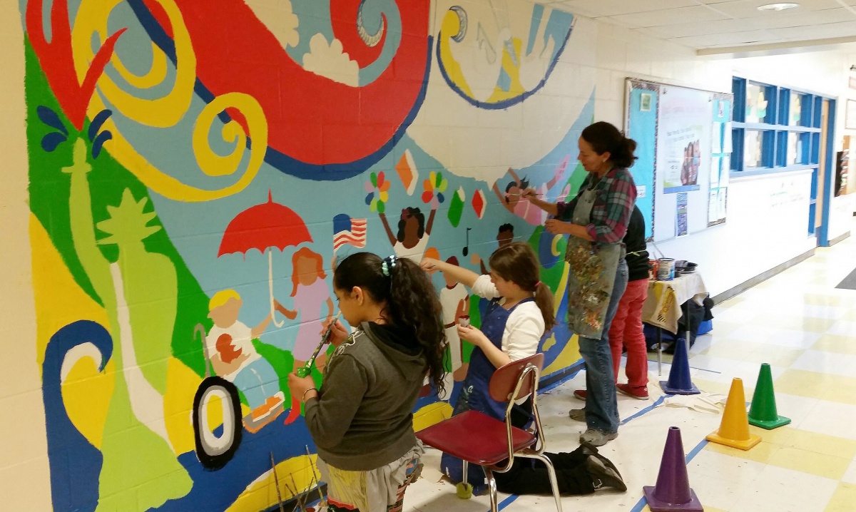 Joyce Raimondo paints mural at East Hampton school