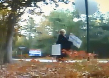 A screenshot of a surveillance video showing political signs being removed in Springs.